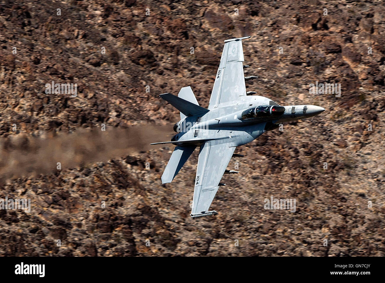 US Navy Boeing F/A-18F Super Hornet NH-104 (SN 166877) from VFA-154 the "Black Knights" flies through the Jedi Transition, R-2508 complex, Star Wars Canyon / Rainbow Canyon, Death Valley National Park, California, United States of America. Stock Photo