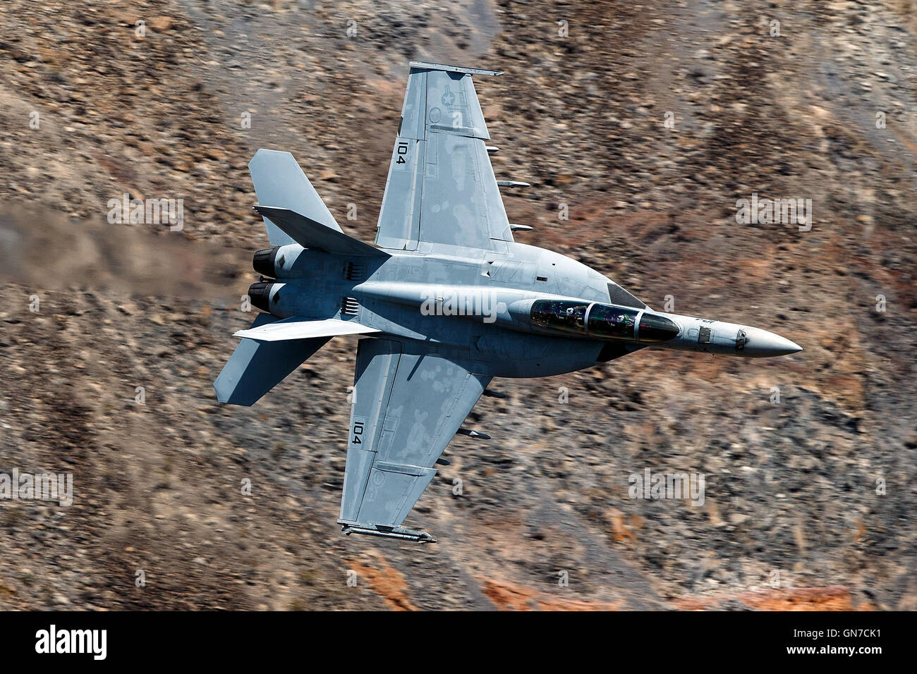 US Navy Boeing F/A-18F Super Hornet NH-104 (SN 166877) from VFA-154 the 'Black Knights' flies through the Jedi Transition, R-2508 complex, Star Wars Canyon / Rainbow Canyon, Death Valley National Park, California, United States of America. Stock Photo