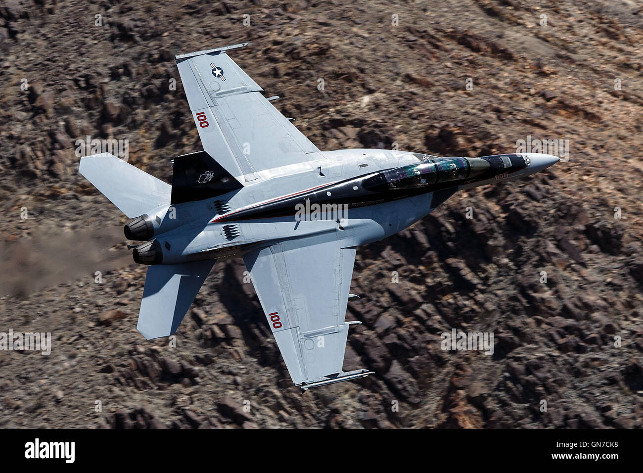 US Navy Boeing F/A-18F Super Hornet NH-100 (SN 166873) from VFA-154 the 'Black Knights' flies through the Jedi Transition, R-2508 complex, Star Wars Canyon / Rainbow Canyon, Death Valley National Park, California, United States of America. Stock Photo