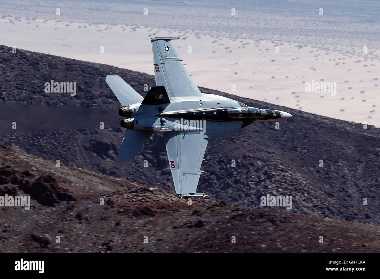 US Navy Boeing F/A-18F Super Hornet NH-100 (SN 166873) from VFA-154 the "Black Knights" flies through the Jedi Transition, R-2508 complex, Star Wars Canyon / Rainbow Canyon, Death Valley National Park, California, United States of America. Stock Photo