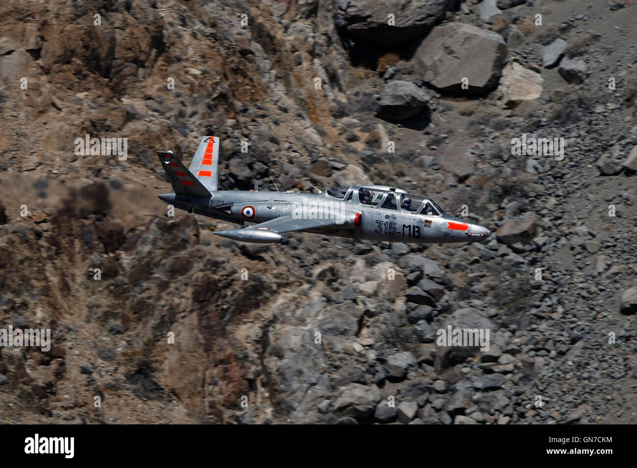 A Fouga CM-170 Magister (registration N315MB) flies low level through Jedi Transition, R-2508 complex, Star Wars Canyon / Rainbow Canyon, Death Valley National Park, California, United States of America. Stock Photo
