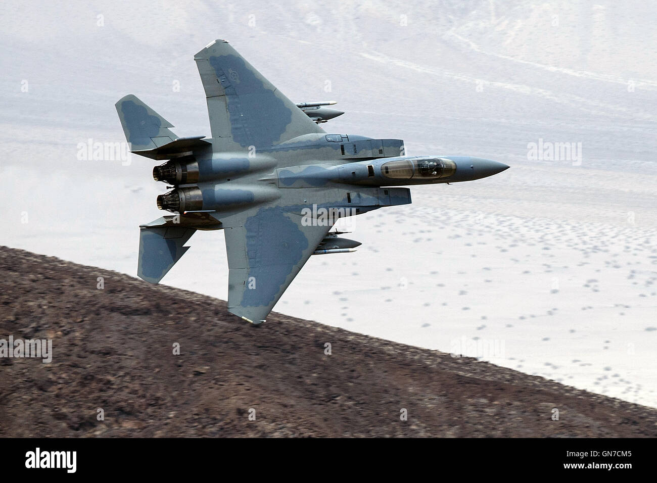 A McDonnell-Douglas F-15C Eagle (78-538), from the 144th Fighter Wing, California Air National Guard Base in Fresno, flies low level through the Jedi Transition, R-2508 complex, Star Wars Canyon / Rainbow Canyon, Death Valley National Park, California, Un Stock Photo