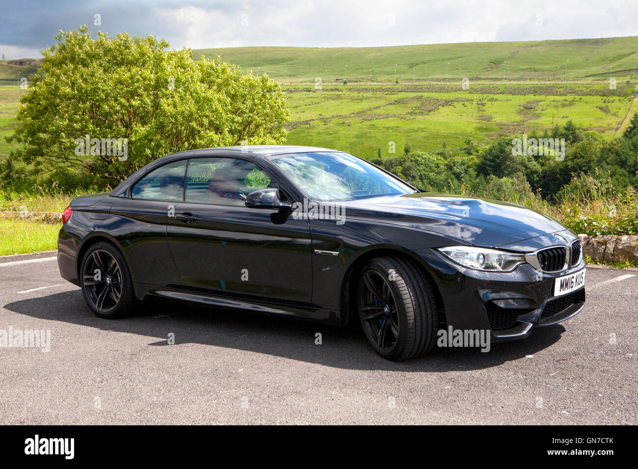 F83 Black BMW M4 convertible 2 door coupe with red leather parked in the countryside in summer Stock Photo