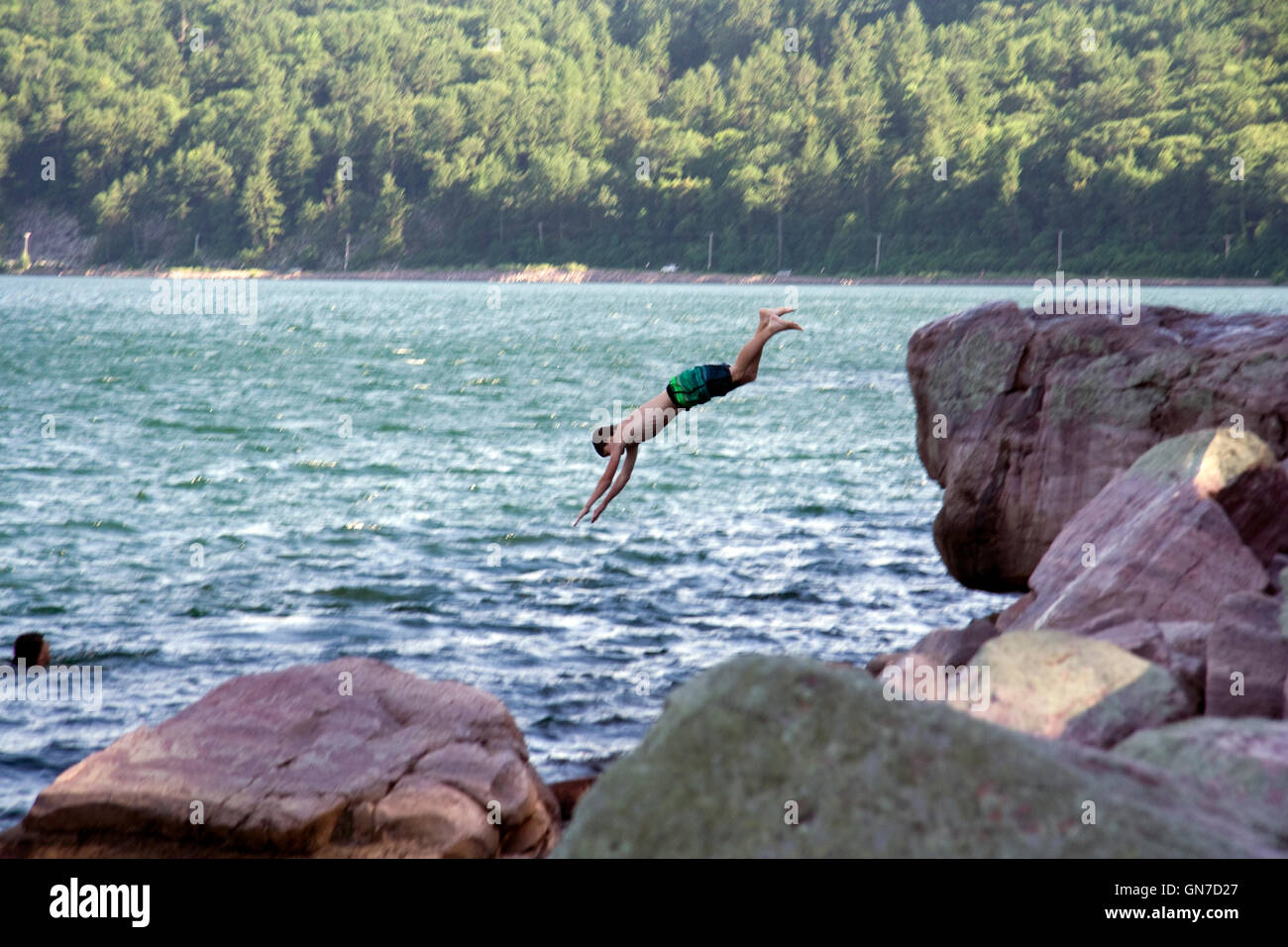 Devil's Lake State Park. Kid is jumping in the water. Stock Photo