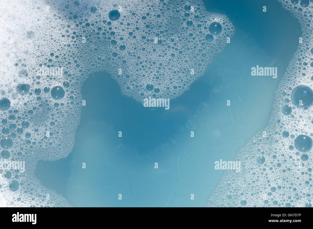 closeup to white foam on blue water Stock Photo