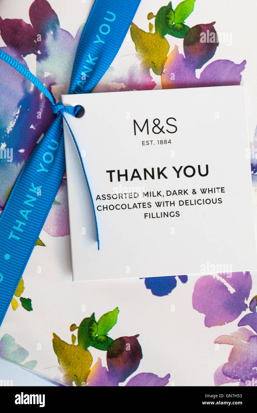 M&S thank you tag and ribbon on box of assorted milk, dark & white chocolates with delicious fillings Stock Photo