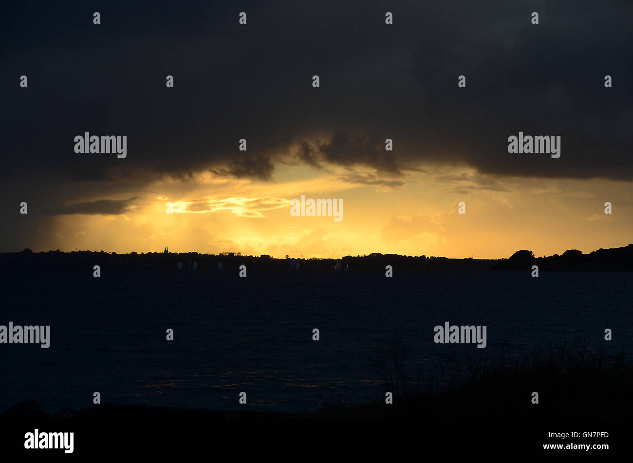 Dark skies over the sea. The small yawls should head for harbor. Stock Photo
