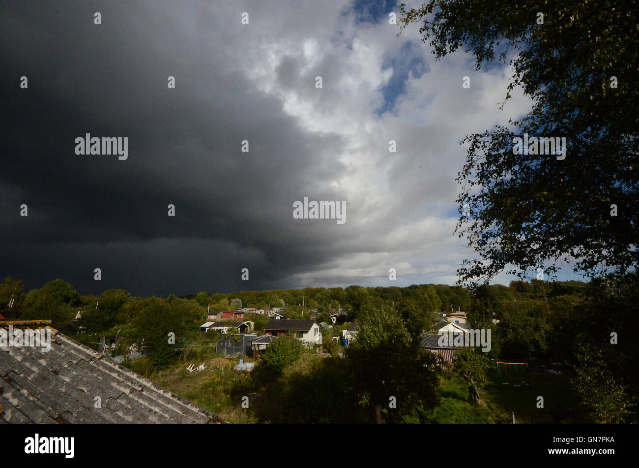 Dark clouds over the village, where allotment garden owners should get indoors. Stock Photo