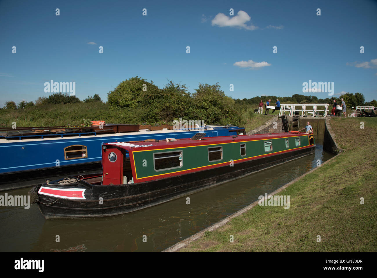 Canal boat on the Kennet and Avon Canal passing through one of the Caen Hill flight of locks at Devizes Wiltshire UK Stock Photo