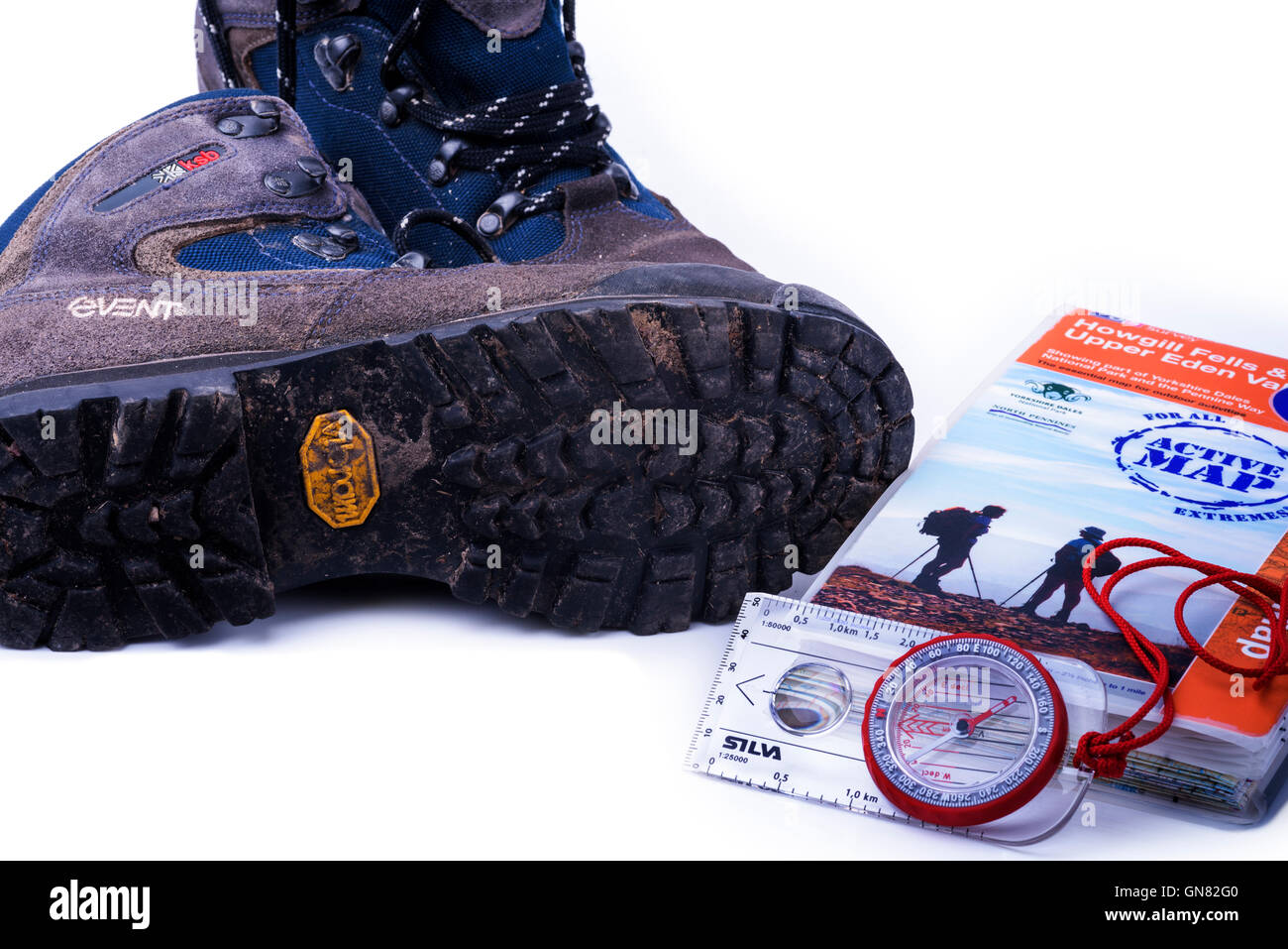 Pair of old walking boots, with a closed map and compass. Stock Photo