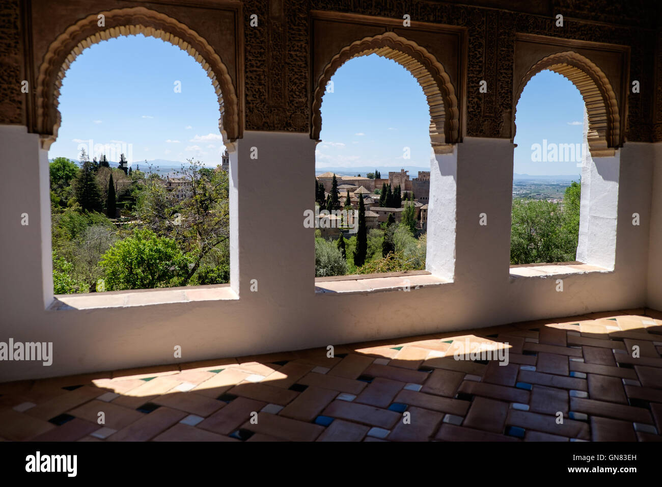 The Alhambra Palace, Granada, Andalucia, seen through arches in the Generalife gardens Stock Photo