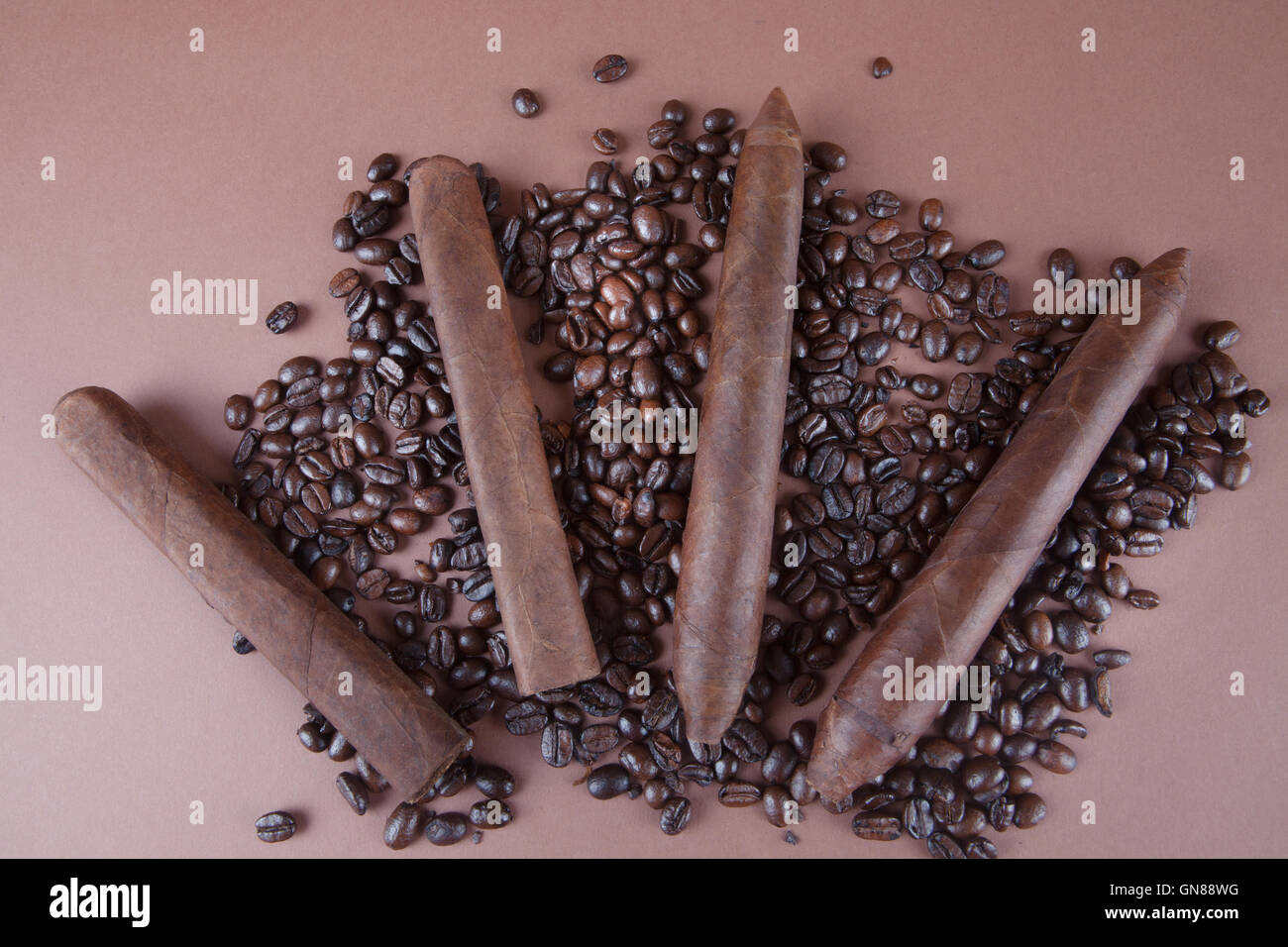 Cigars and Cuban Coffee beans on brown background Stock Photo