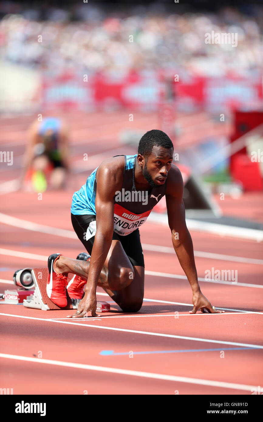 Brazilian athlete wearing flip flops crouching at the start