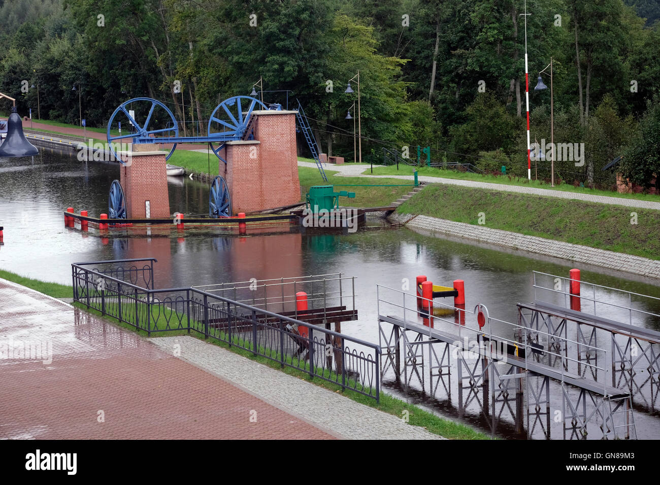 View of cable winch and water lock at Buczyniec in Elbag canal in Warmian-Masurian region, Northern Poland. Built in the 19th century, the Elblag to Ostroda Canal deals with the 99.5m difference in water levels by means of a system of slipways, locks, dams and safety gates. Five slipways carry boats across dry land on rail-mounted trolleys. Stock Photo