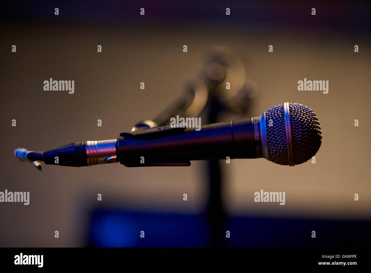 shure microphone on boom stand wired on stage in a theatre Stock Photo