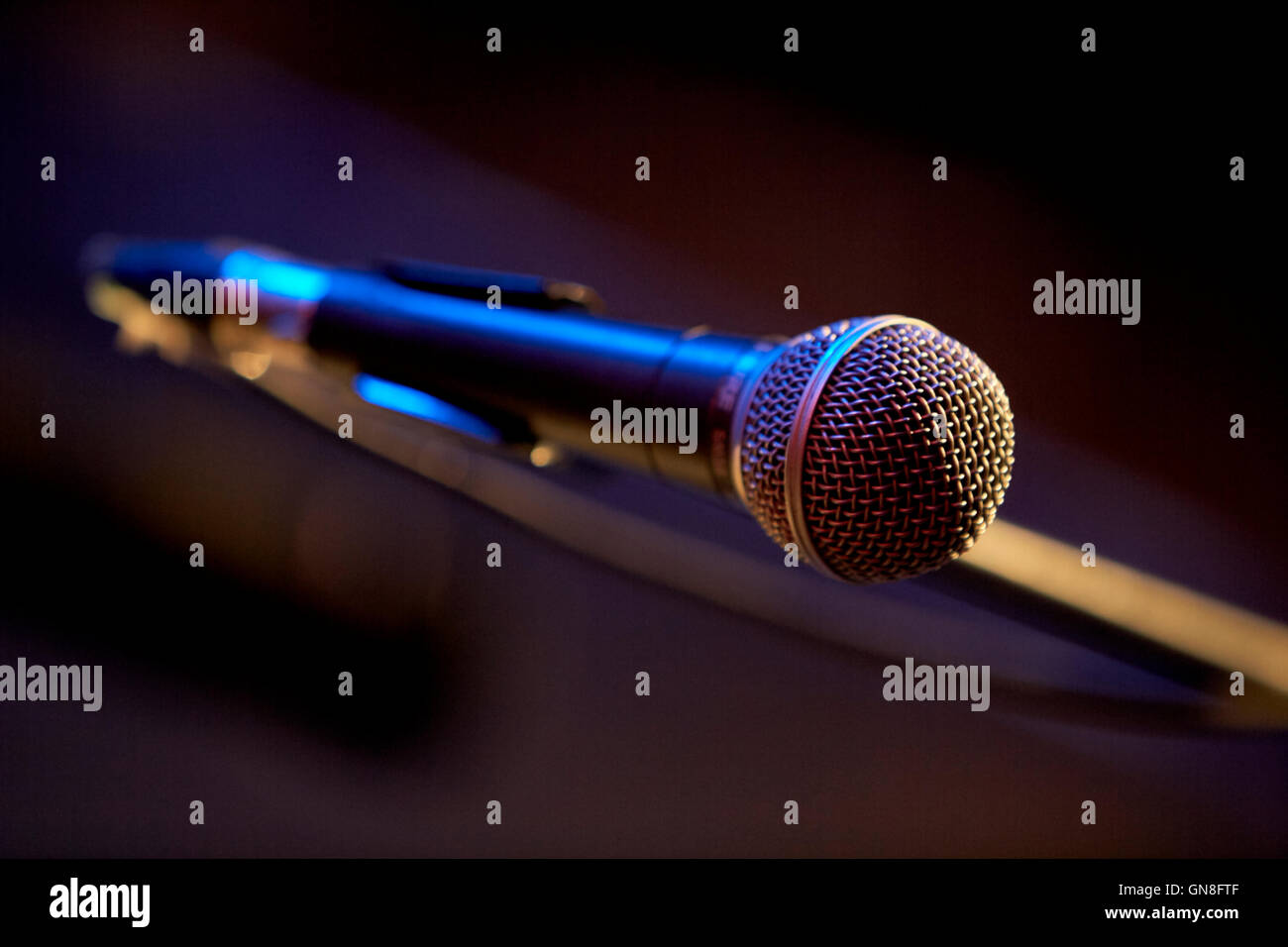 shure microphone on boom stand wired on stage in a theatre Stock Photo