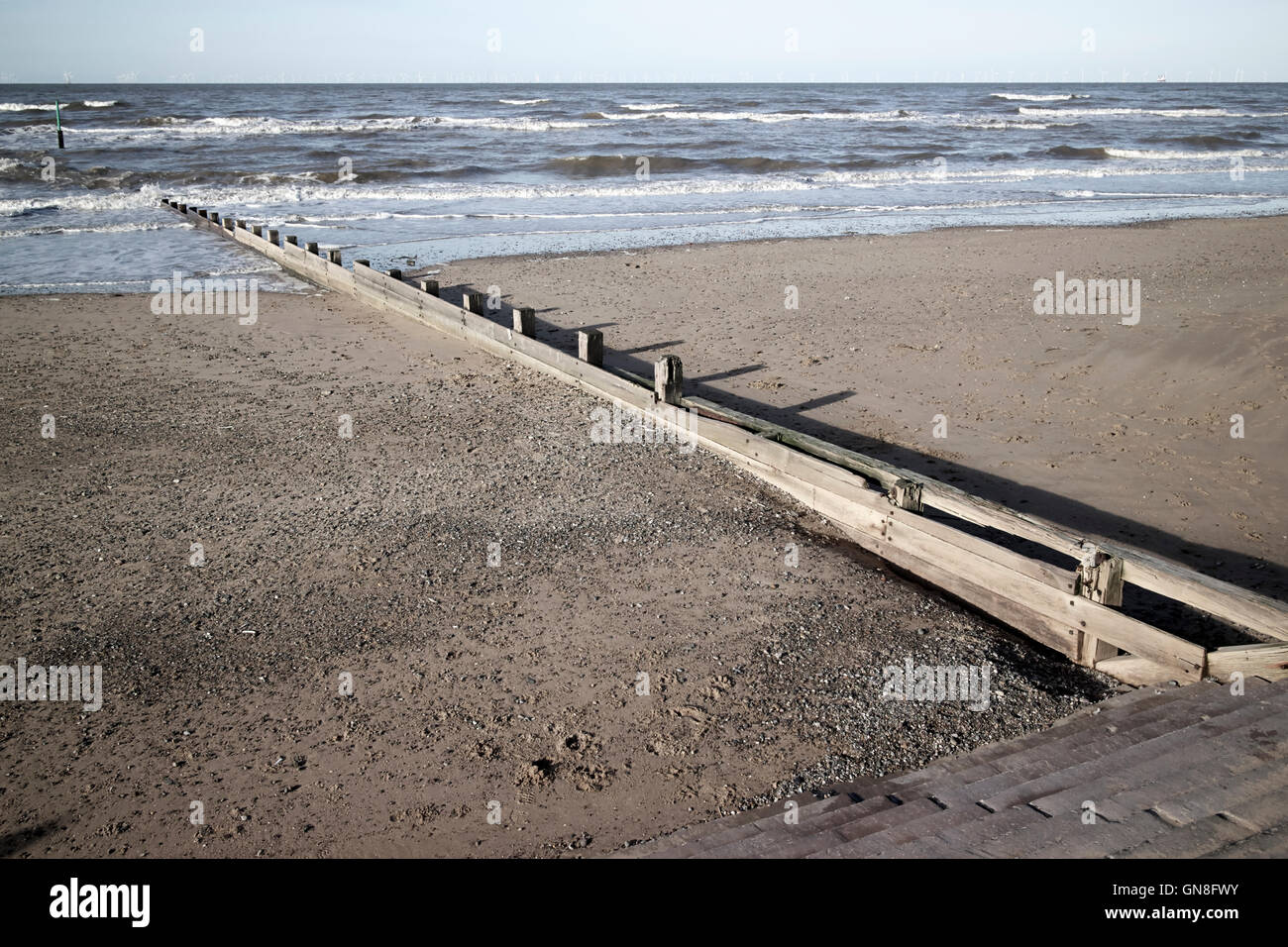 wooden groyne sea defences on the beach at rhyl north wales Stock Photo
