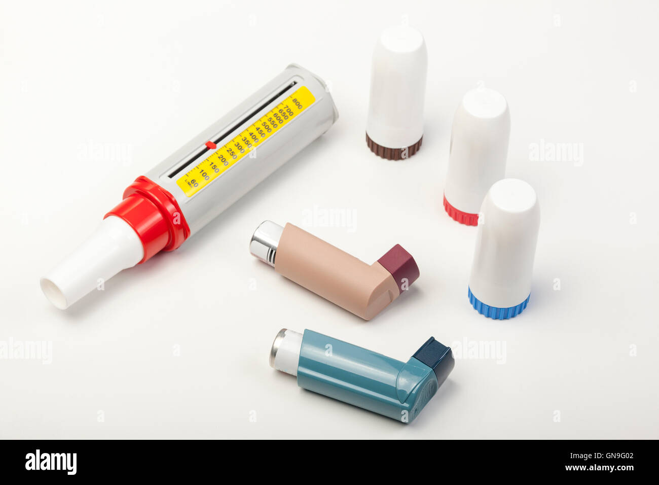 Various types of spray and powder asthma inhalers and a peek low meter on a white background Stock Photo