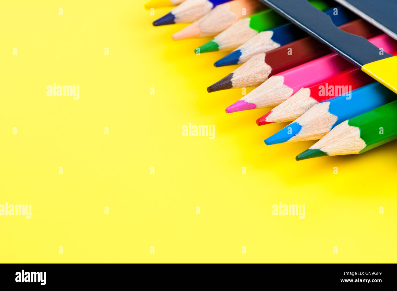 Pencils on yellow background Stock Photo - Alamy