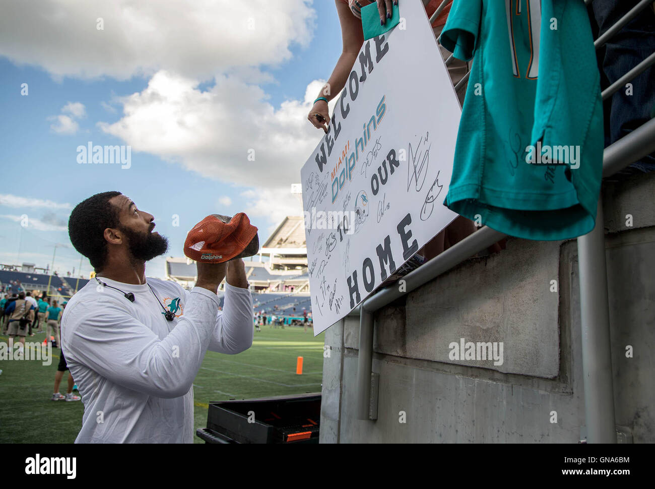 Orlando, Florida, USA. 29th Aug, 2016. Miami Dolphins linebacker Spencer Paysinger (42) signs autographs at Camping World Stadium in Orlando, Florida on August 25, 2016. Credit:  Allen Eyestone/The Palm Beach Post/ZUMA Wire/Alamy Live News Stock Photo
