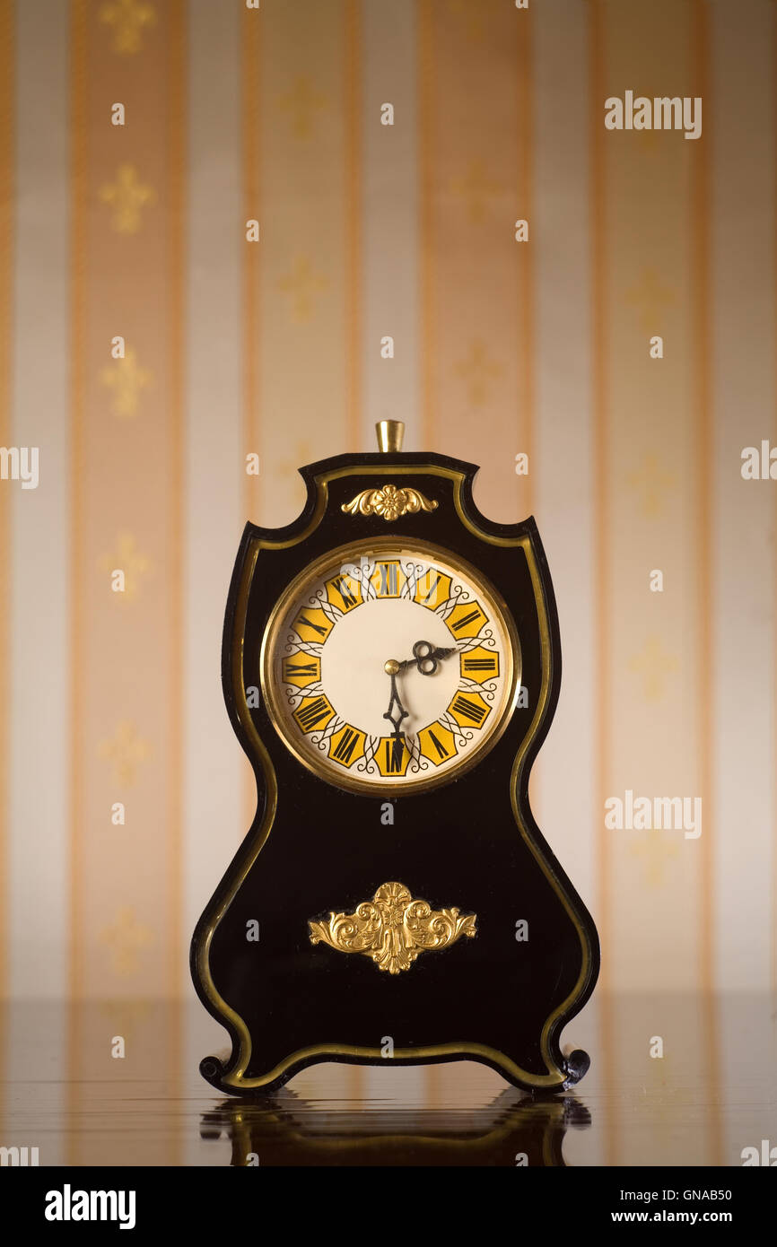 Vintage clocks on wallpaper background Stock Photo - Alamy