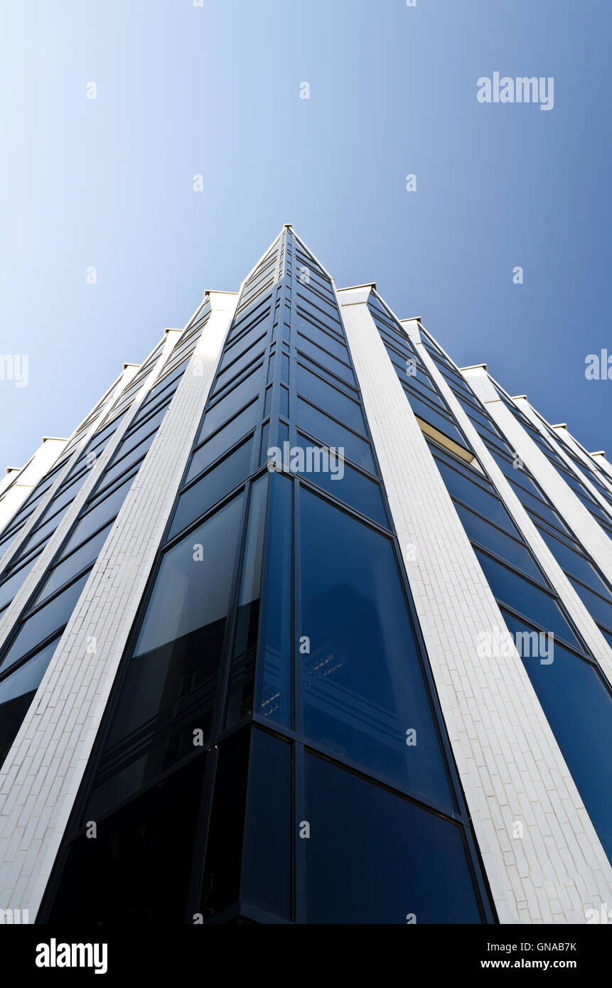 Office building under blue cloudless sky Stock Photo - Alamy