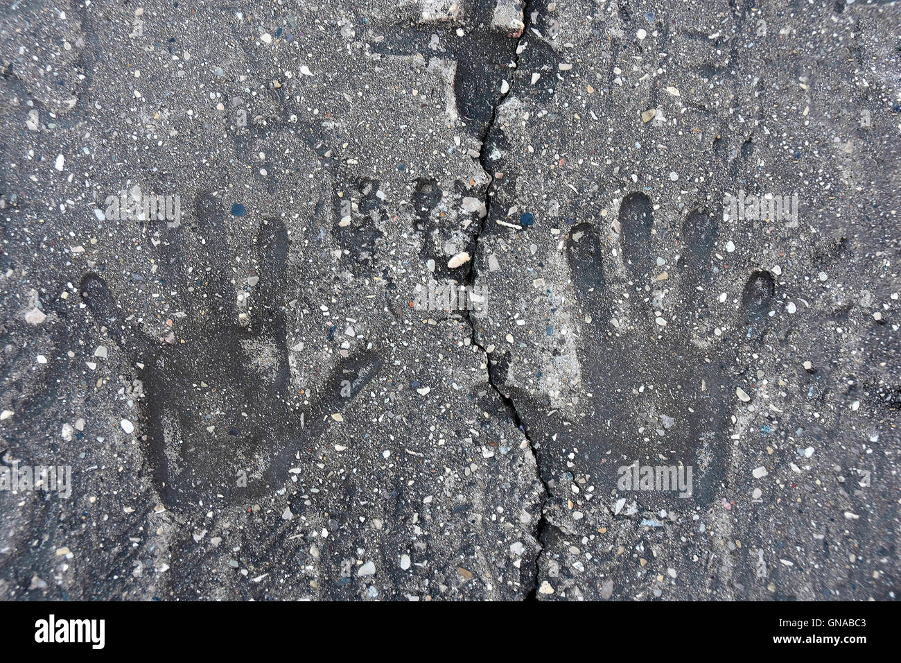 Pair of hand print indentations in concrete Stock Photo