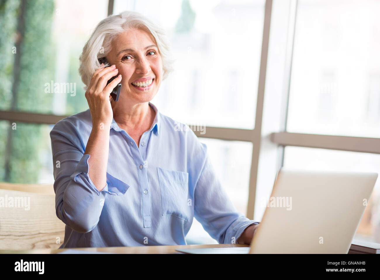 Joyful senior woman talking on cell phone Stock Photo - Alamy