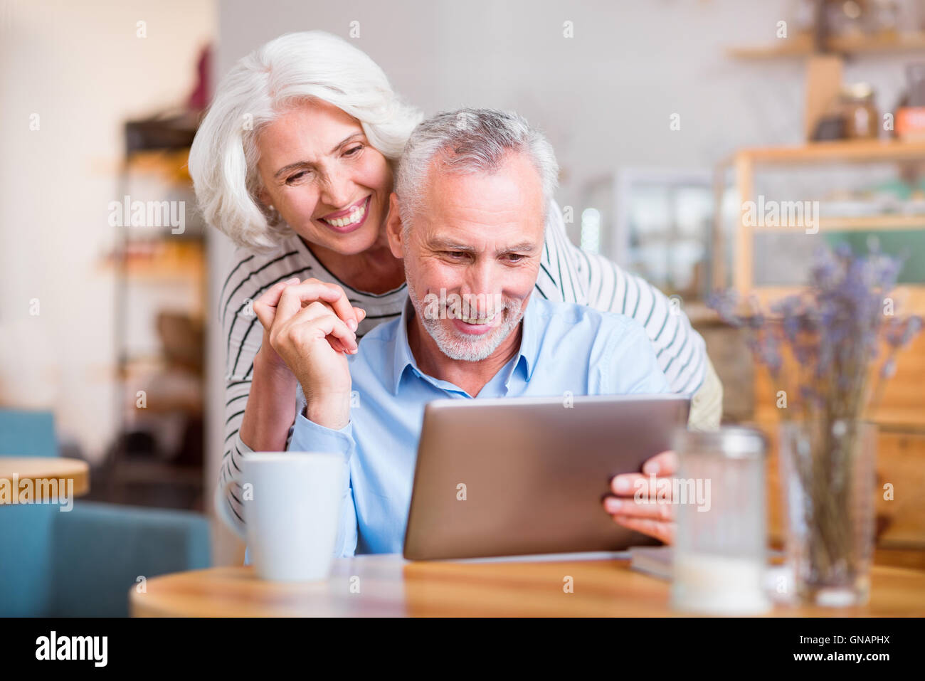 Delighted couple using tablet hi-res stock photography and images - Alamy