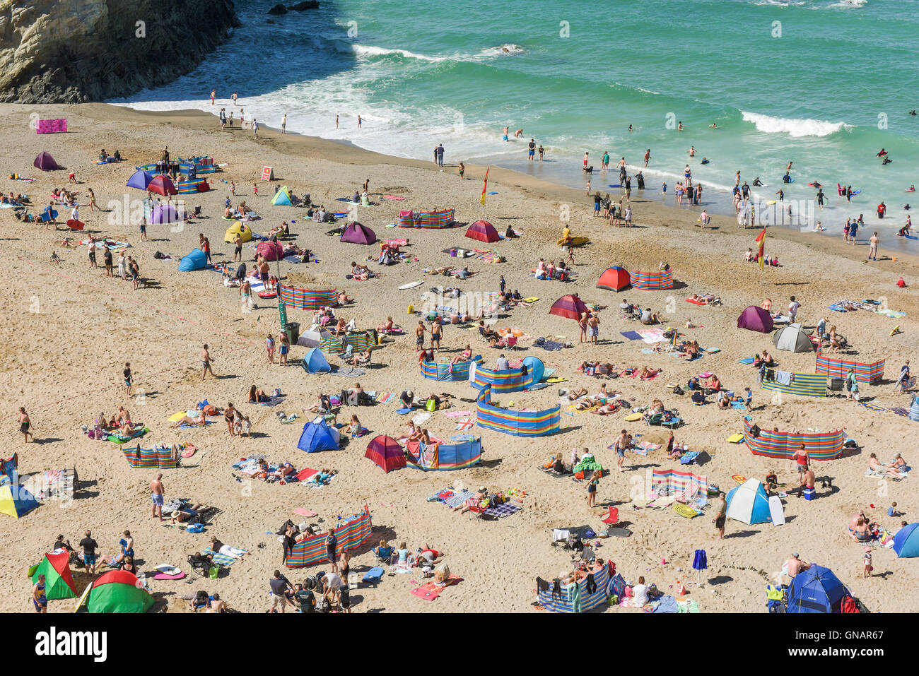 Holidaymakers relax on Lusty Glaze beach in Newquay, Cornwall. Stock Photo