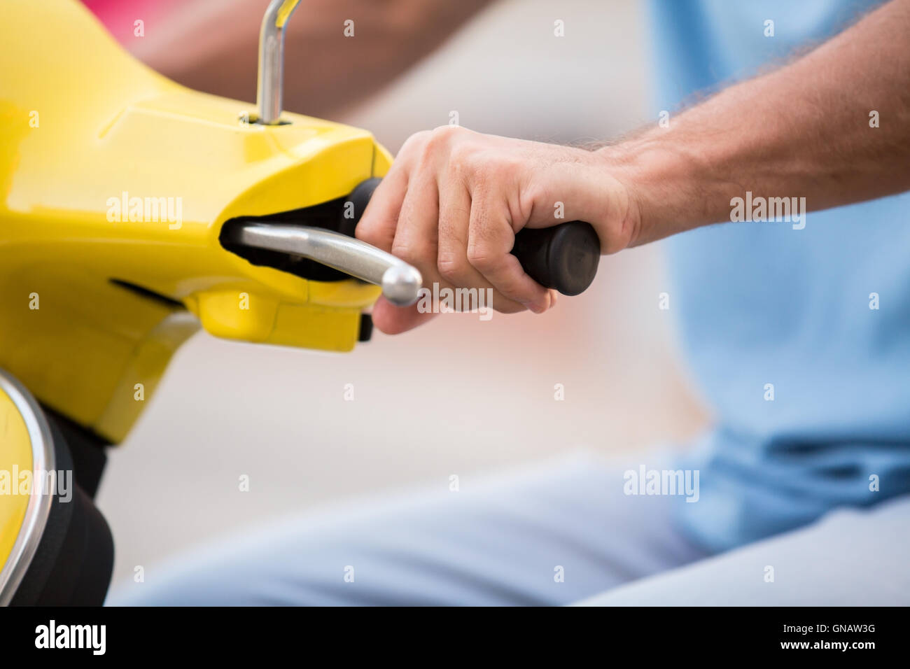 Hand on scooter's steering wheel. Stock Photo