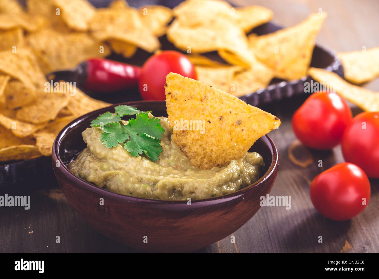 Fresh guacamole sauce with corn chips Stock Photo