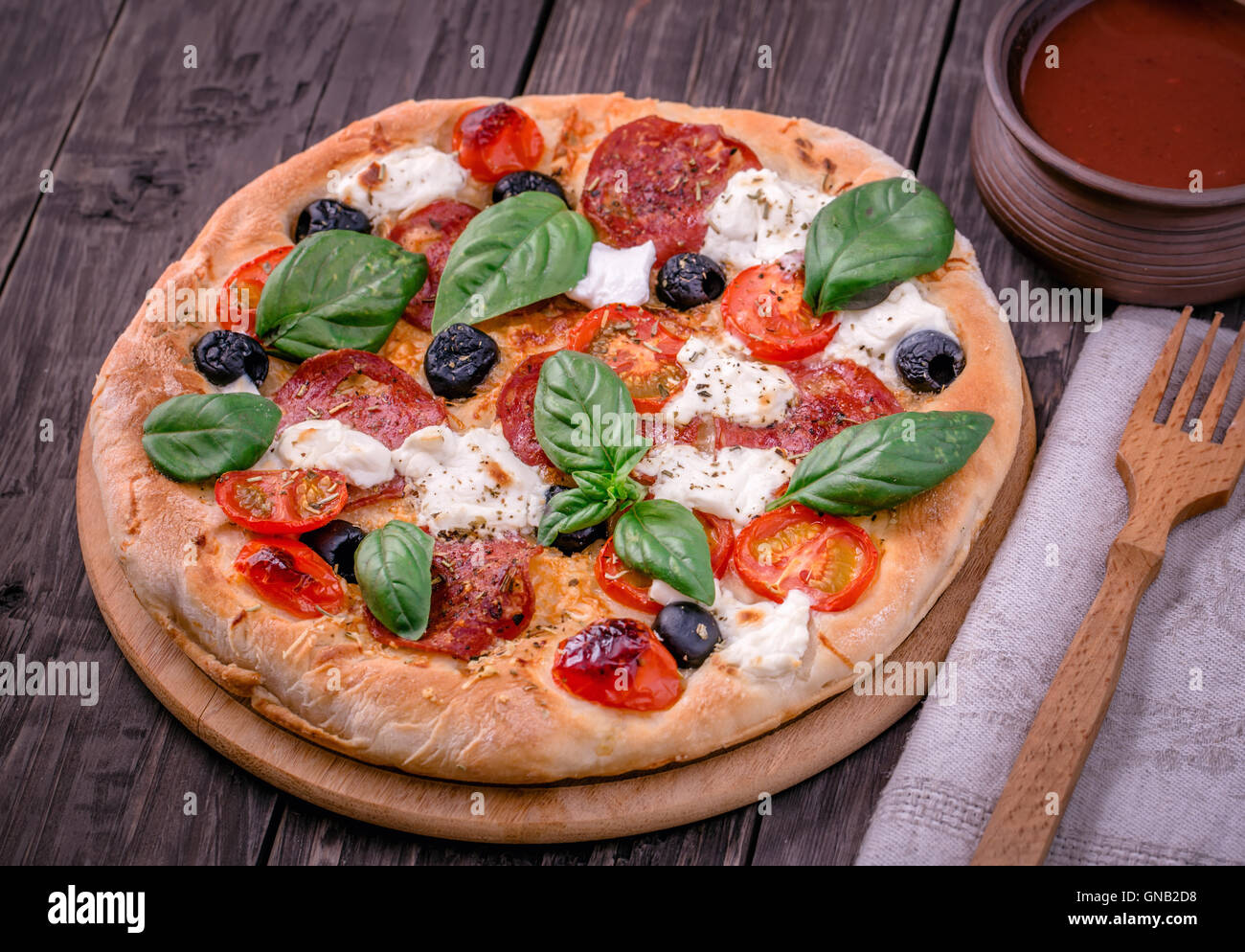 Fresh pizza with salami and mozzarella rustic Stock Photo - Alamy