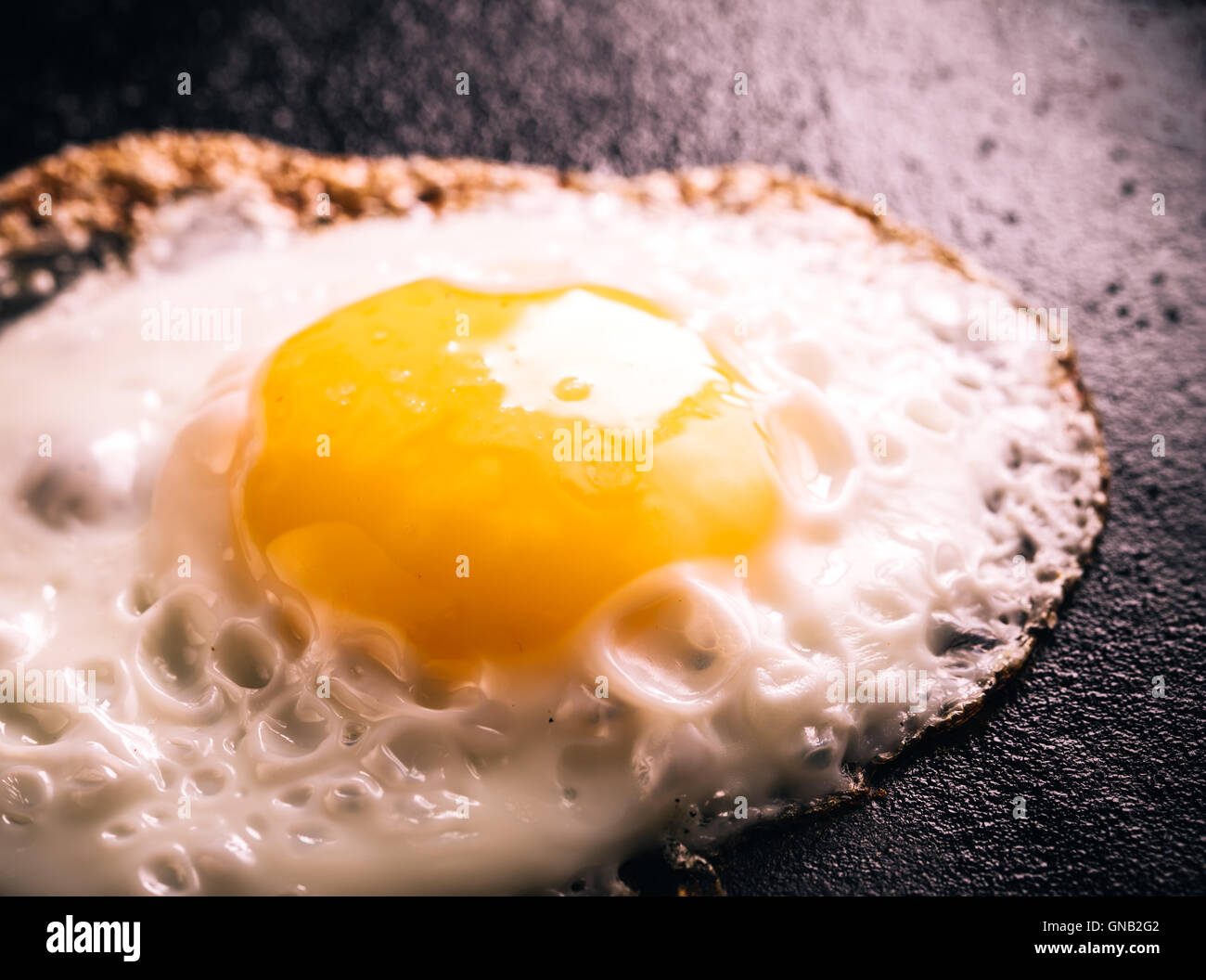 Fried egg on frying pan Stock Photo - Alamy
