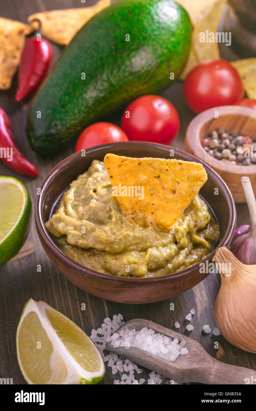 Guacamole sauce with corn chips Stock Photo