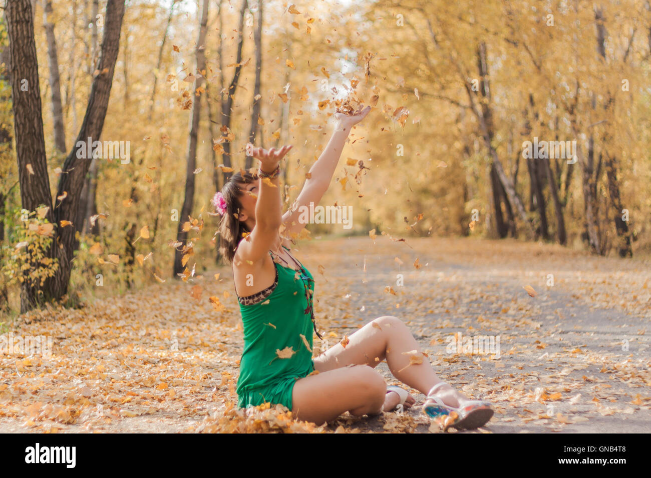 Happy woman playing with autumn leaves Stock Photo - Alamy