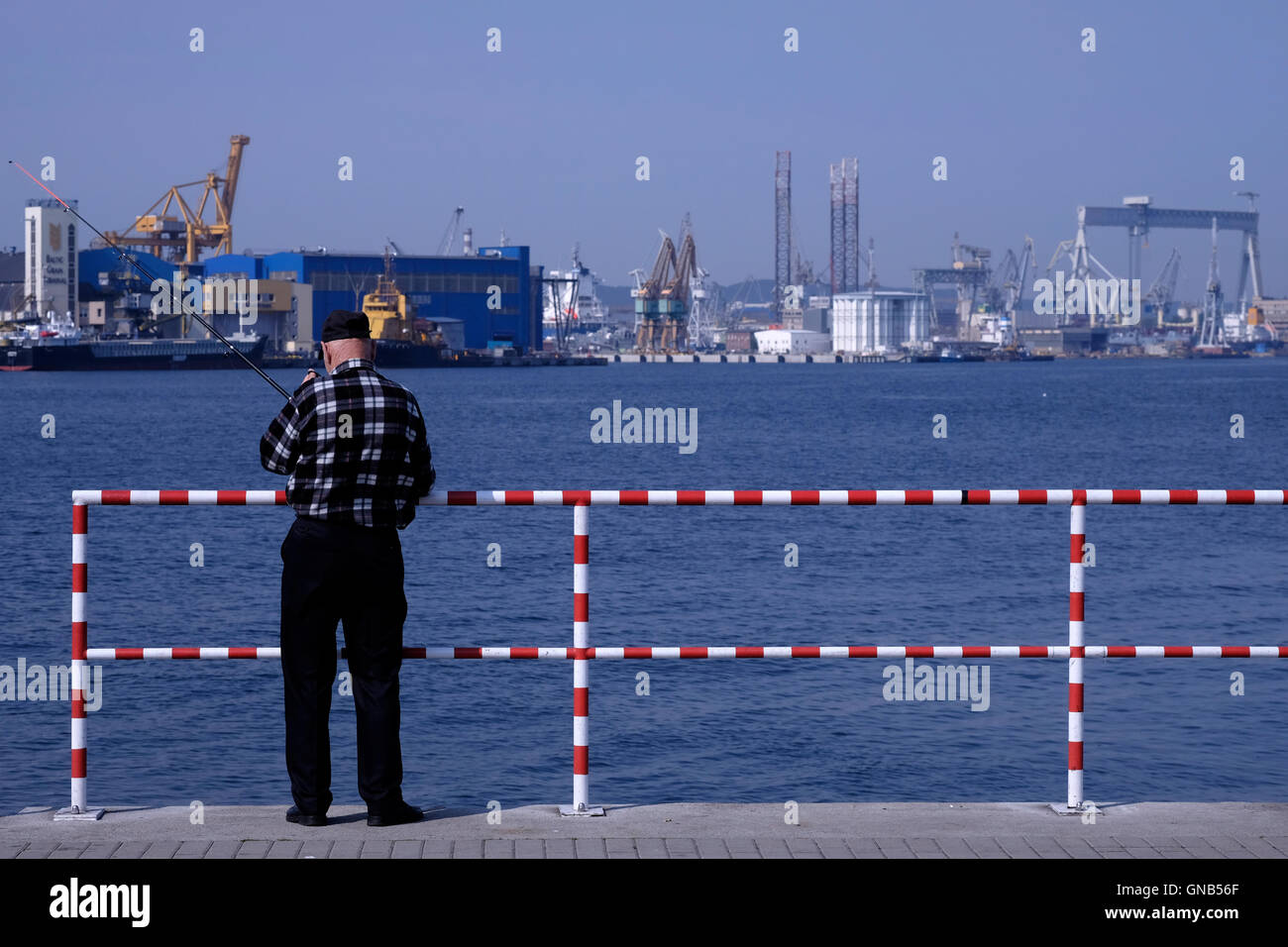 Man fishing at the dockyard of Gdynia in Gdansk Bay northern Poland Stock Photo