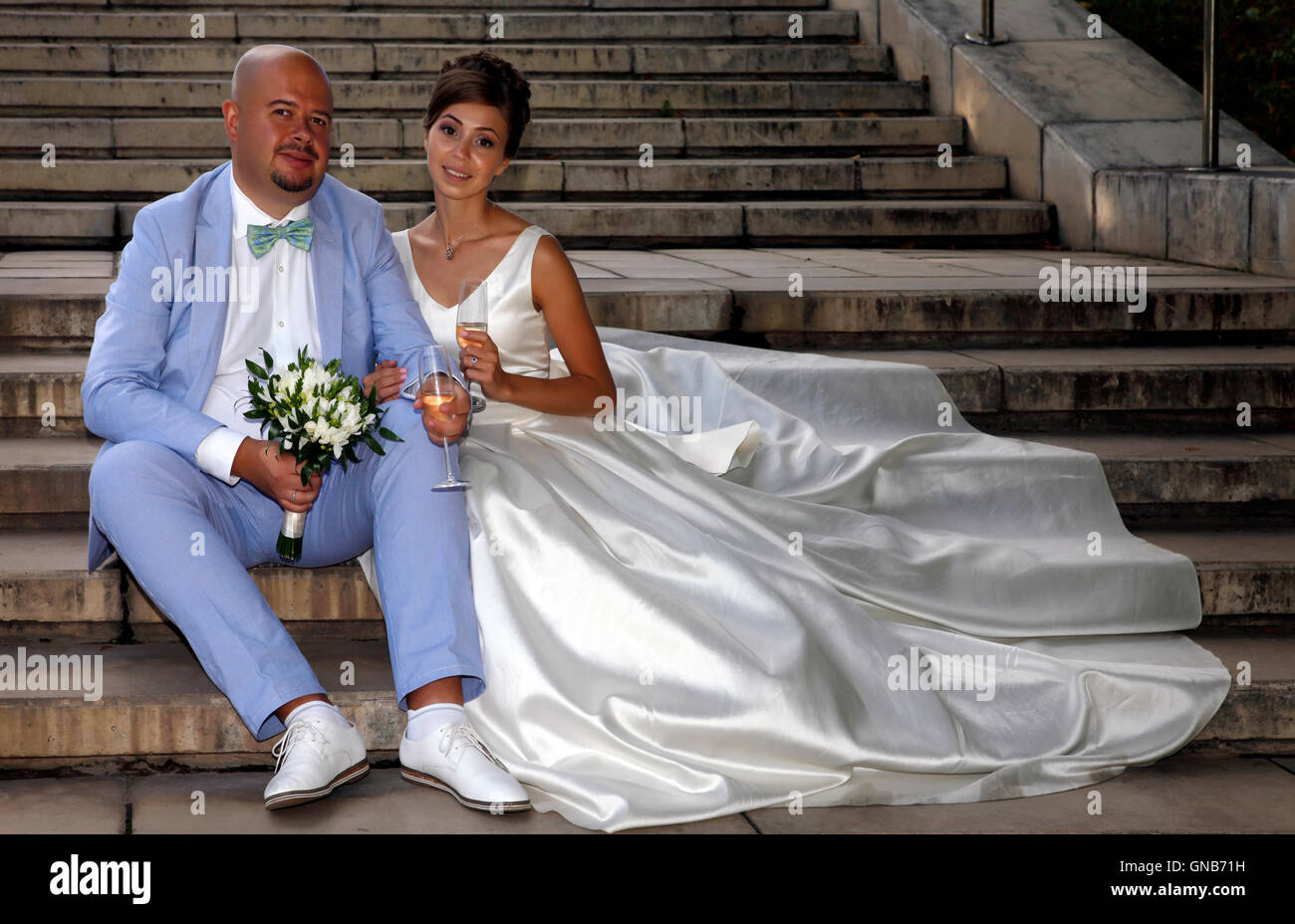 Bride sitting on stairs hi-res stock photography and images - Alamy