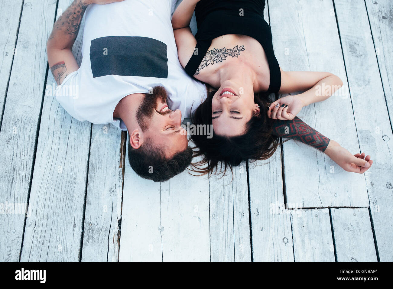 man and woman lie on the wooden floor Stock Photo - Alamy