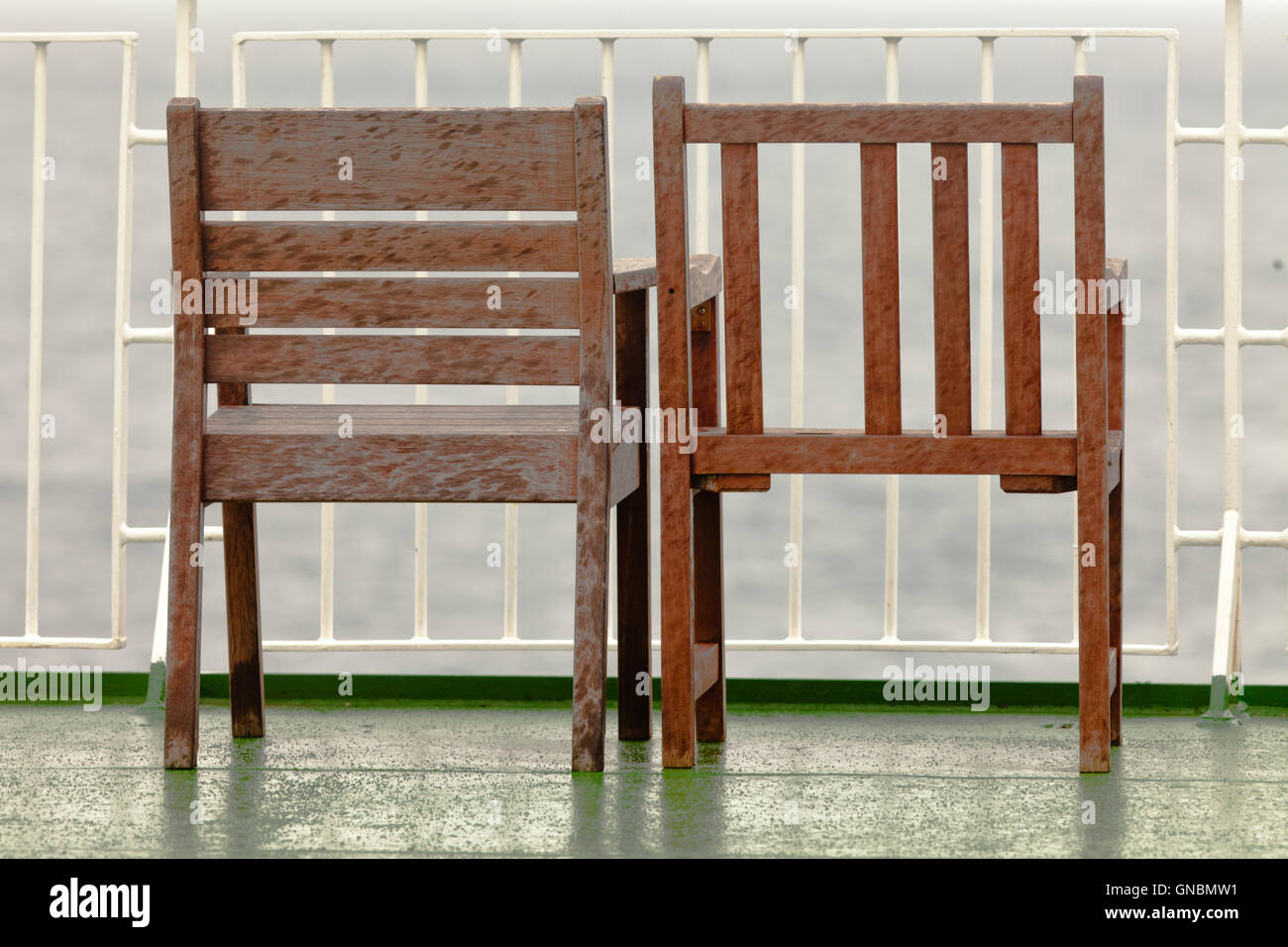 Two empty wooden chairs on balcony Stock Photo