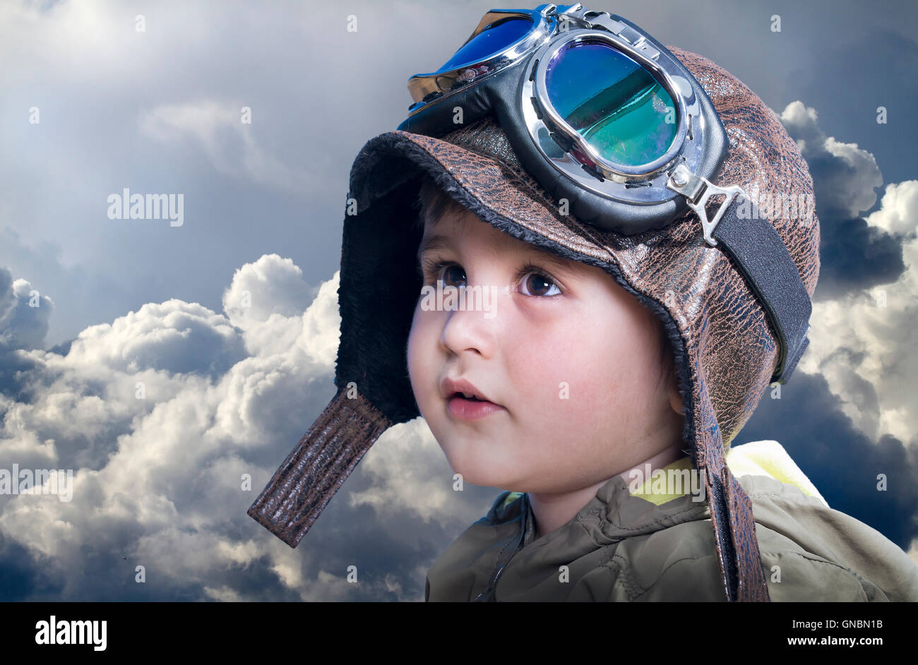 A little cute baby dreams of becoming a pilot. Pilot outfit, hat Stock Photo