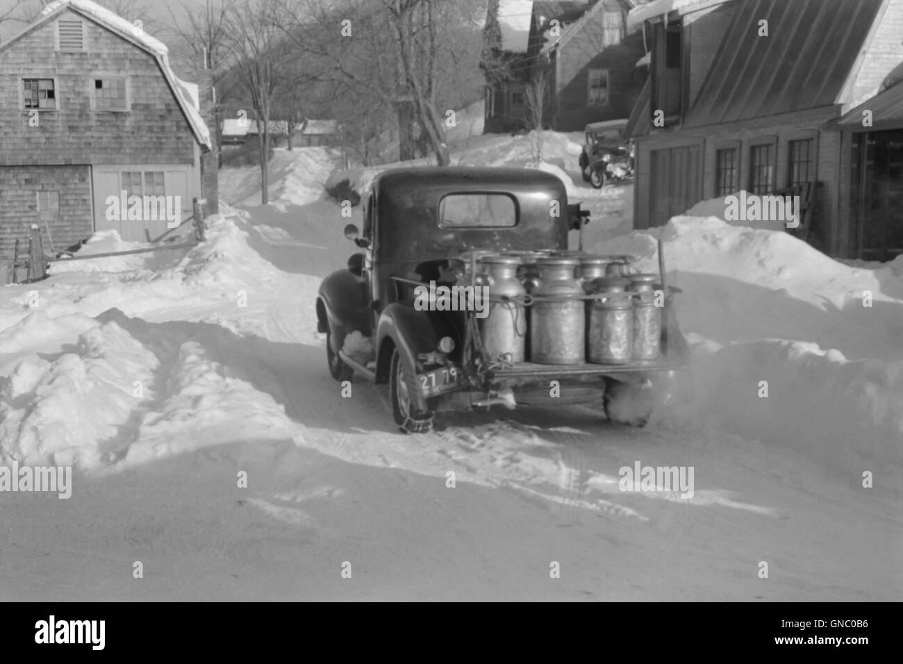 Farmer Delivering Milk Cans in Truck, near Woodstock, Vermont, USA, Marion Post Wolcott for Farm Security Administration, March 1940 Stock Photo