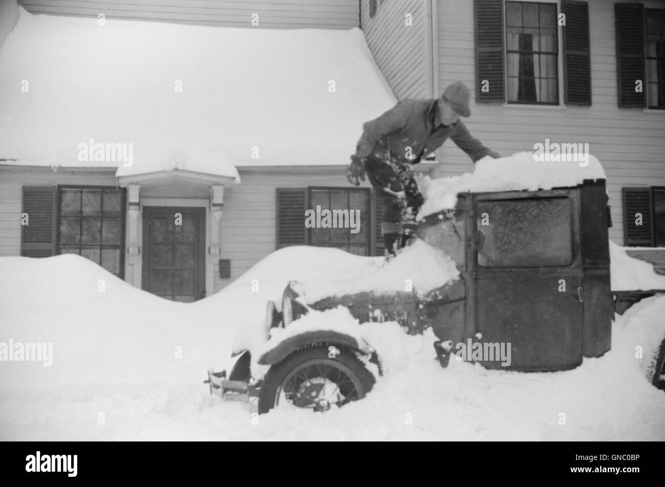 Man Clearing Snow from Truck after Heavy Snowfall, Woodstock, Vermont, USA, Marion Post Wolcott for Farm Security Administration, March 1940 Stock Photo