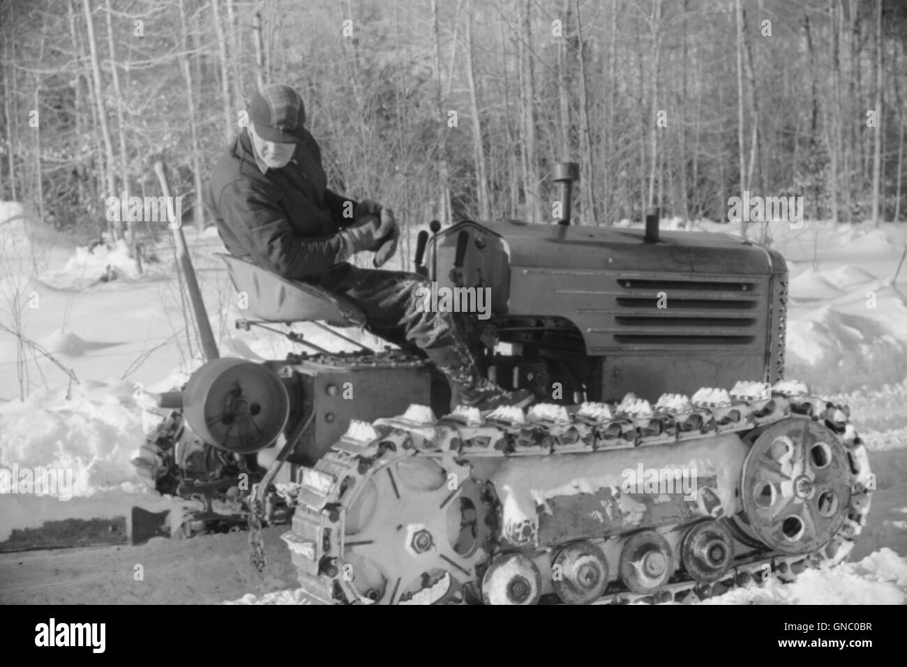 Hauling Timber by Tractor to Road where it is Taken by Truck to Mill, near Barnard, Vermont, USA, Marion Post Wolcott for Farm Security Administration, March 1940 Stock Photo