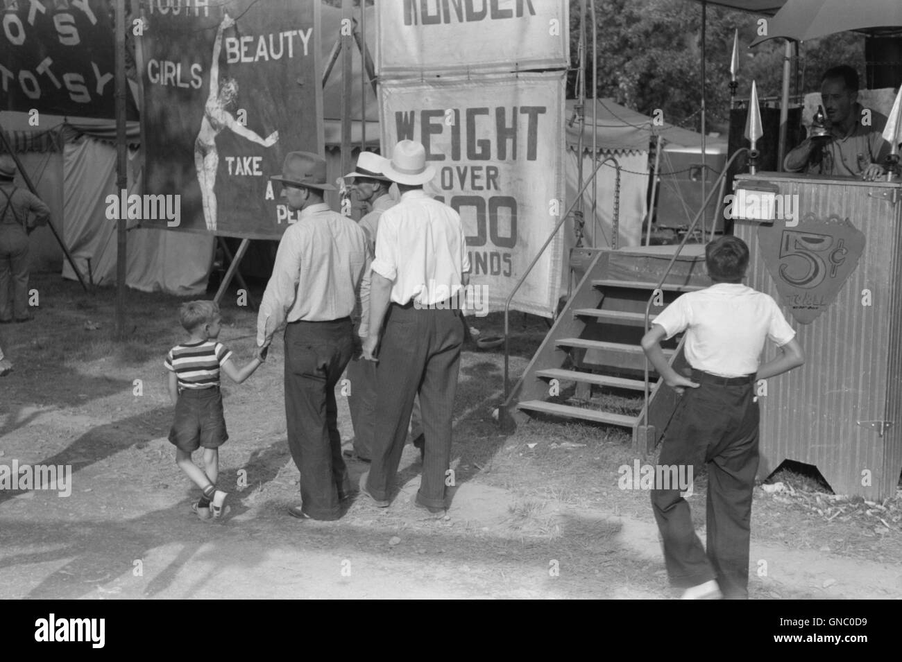Group of Men and Children at Midway and Carnival, Shelby County Fair and Horse Show, Shelbyville, Kentucky, USA, Marion Post Wolcott, U.S. Farm Security Administration, August 1940 Stock Photo