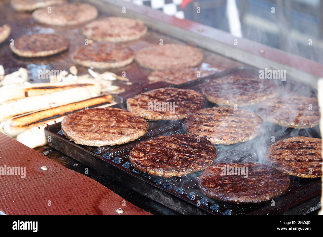 hamburger and hot dog stall selling hot fast food at an outdoor market