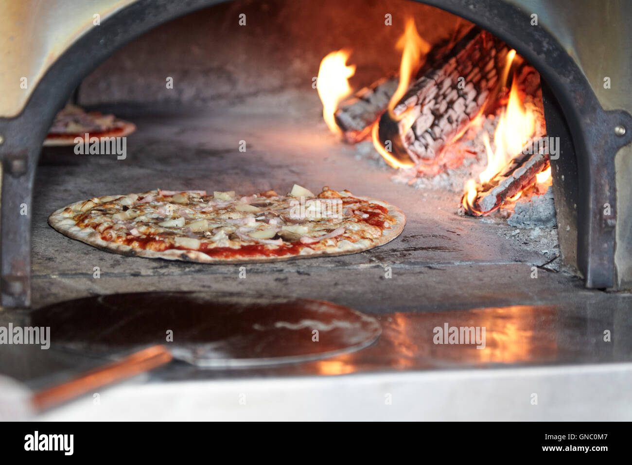 Thermometer with glowing embers in an outdoor wood-burning pizza oven for  cooking and baking Stock Photo - Alamy