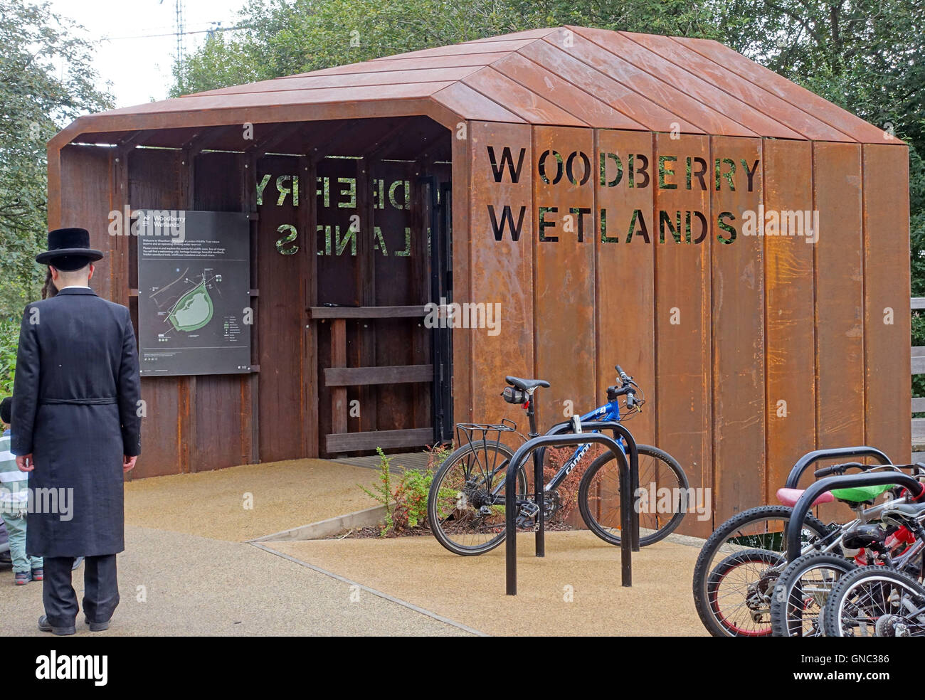 Hasidic Jewish man by entrance to Woodberry Wetlands nature  reserve, North London Stock Photo