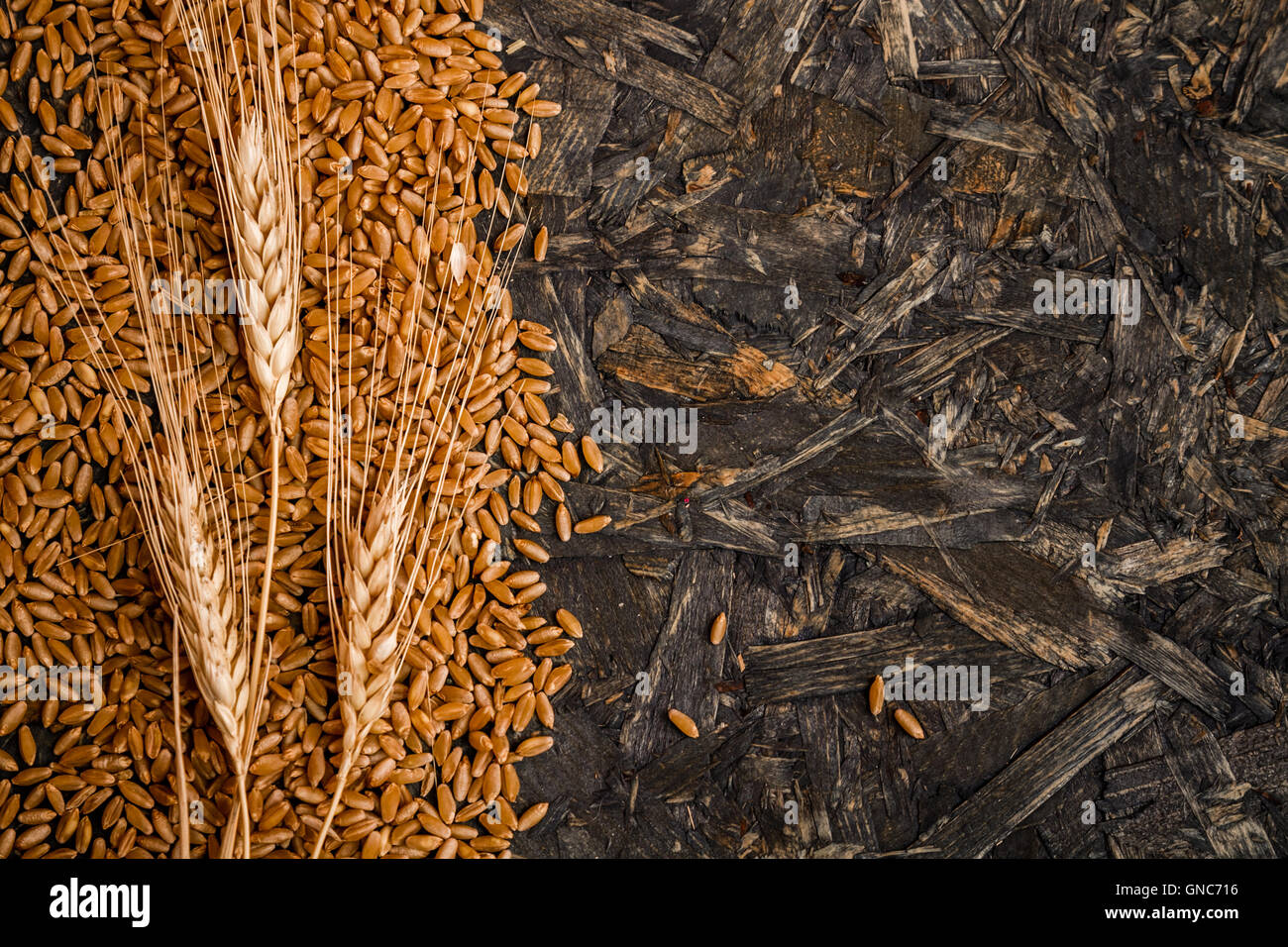 Ears of wheat and grains on wooden background Stock Photo - Alamy