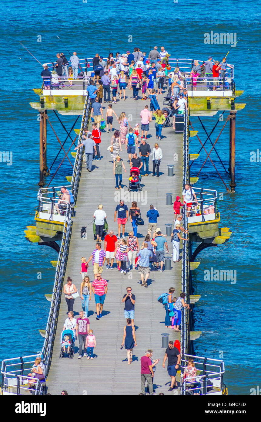 Crowds of people enjoying Saltburn Pier on a sunny Bank Holiday Stock Photo